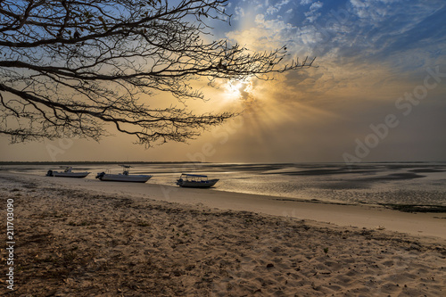View of a beautiful deserted beach in the island of Orango at sunset, in Guinea Bissau. Orango is part of the Bijagos Archipelago; Concept for travel in Africa and summer vacations