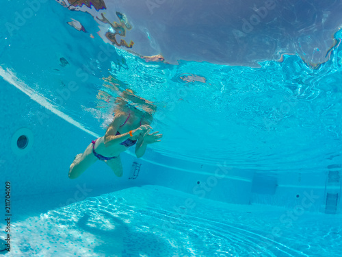 Young woman enjoying in the swimming pool