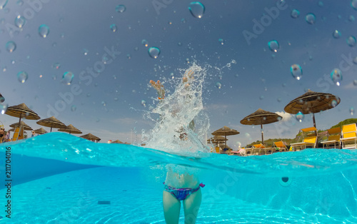 Young woman enjoying in the swimming pool