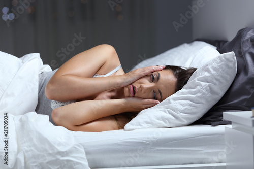 Desperate girl suffering insomnia trying to sleep