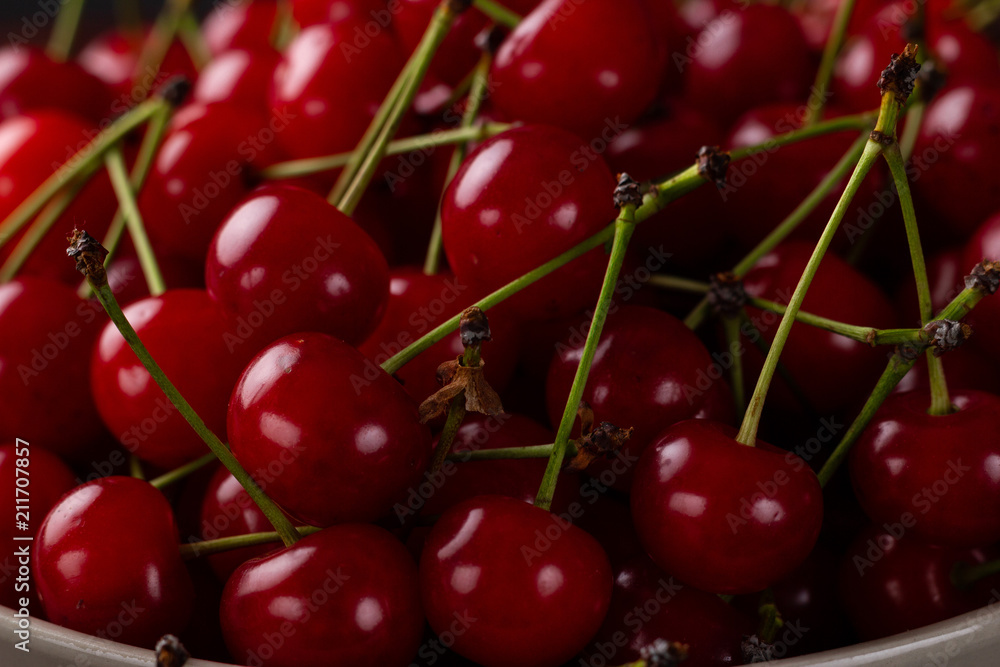 Fresh cherry on a plate with summer flowers. fresh ripe berries. cherries. Close-up Fresh cherry on a plate with summer flowers. fresh ripe berries. cherries. Close-up