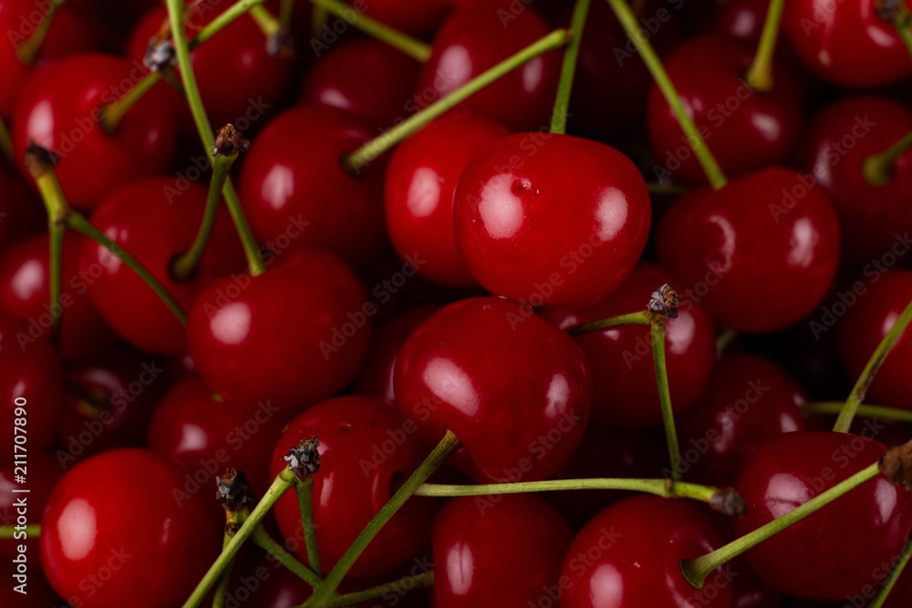 Fresh cherry on a plate with summer flowers. fresh ripe berries. cherries. Close-up. Top view. Fresh cherry on a plate with summer flowers. fresh ripe berries. cherries. Close-up. Top view.