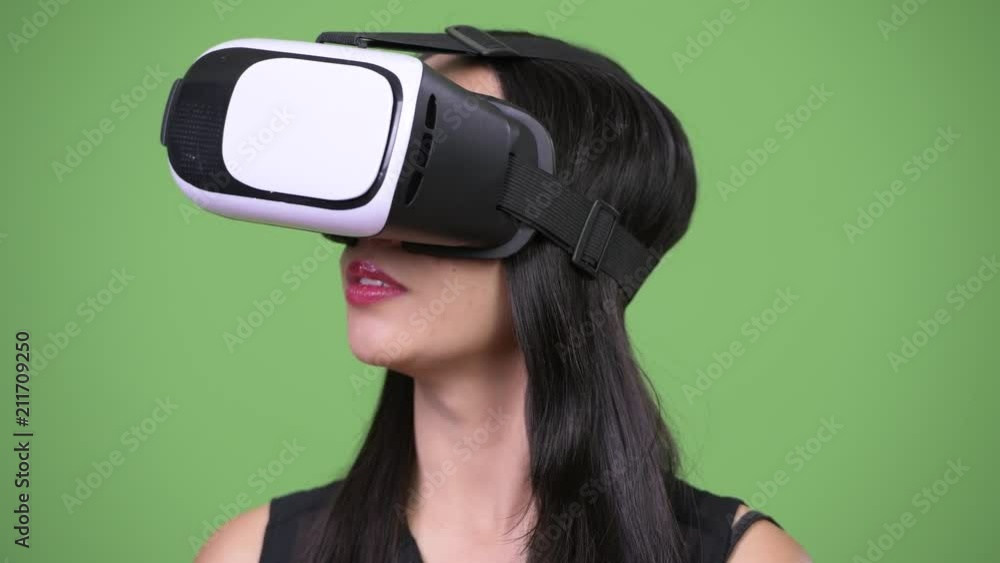 Young beautiful Asian businesswoman using virtual reality headset Young beautiful Asian businesswoman using virtual reality headset