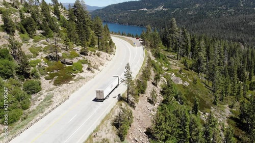 Cars driving on mountain road over Donner Lake photo