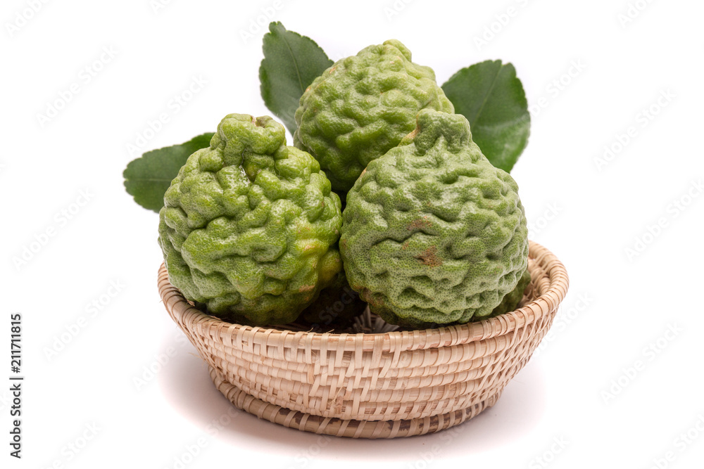 Fototapeta premium The kaffir lime leaves in the basket on a white background.