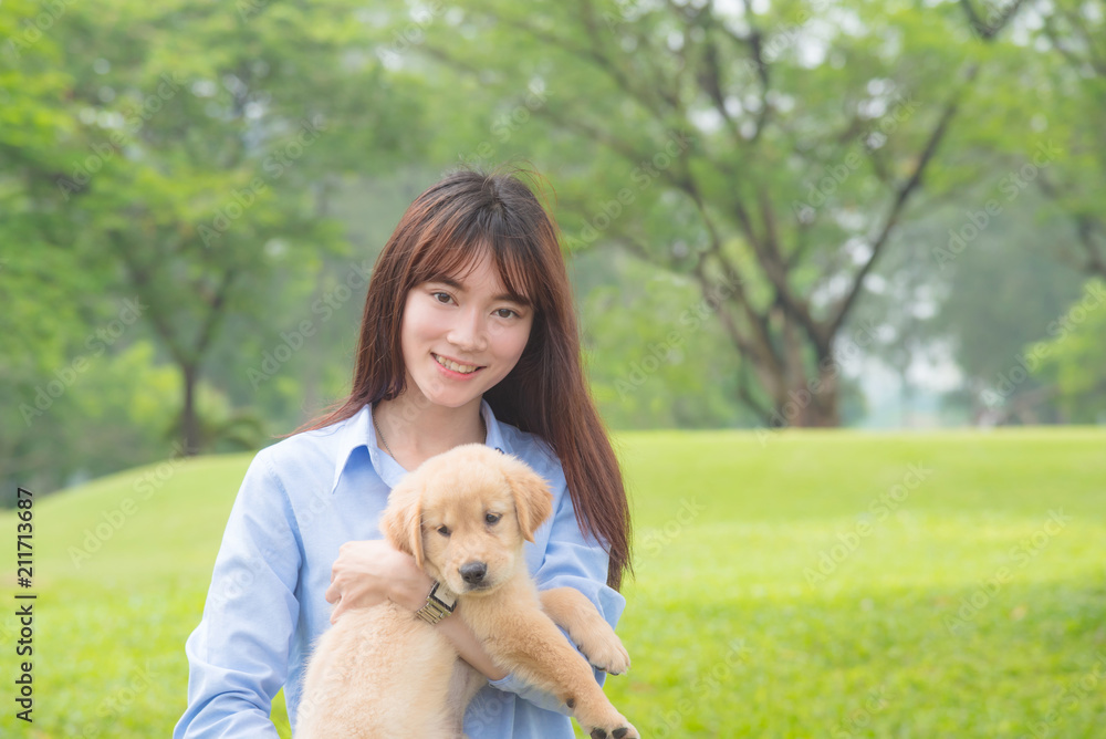 Beautiful asian girl smiling with her little dog in park Beautiful asian girl smiling with her little dog in park