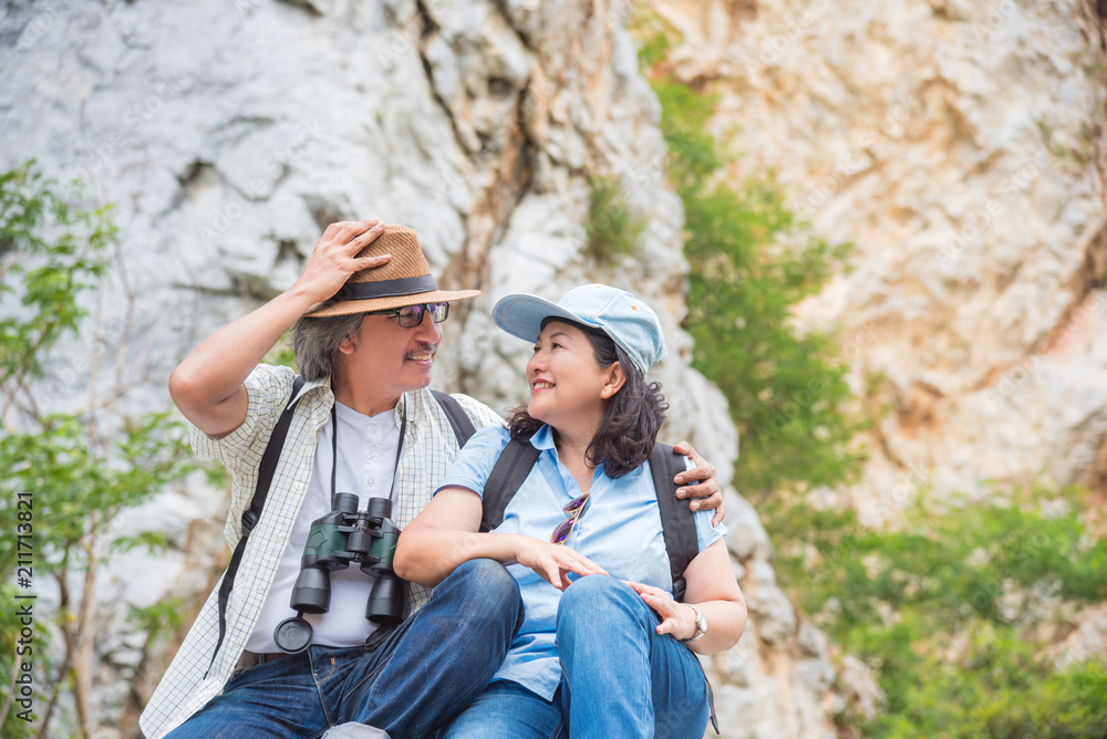 Retired asian couple sitting on the hill and smile together Retired asian couple sitting on the hill and smile together