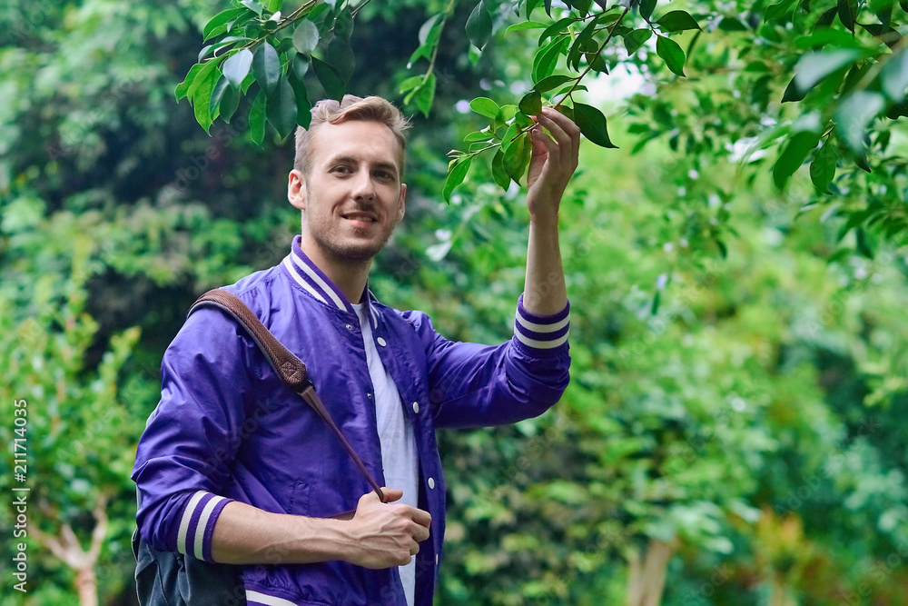 Man traveling in the forest with backpack Man traveling in the forest with backpack