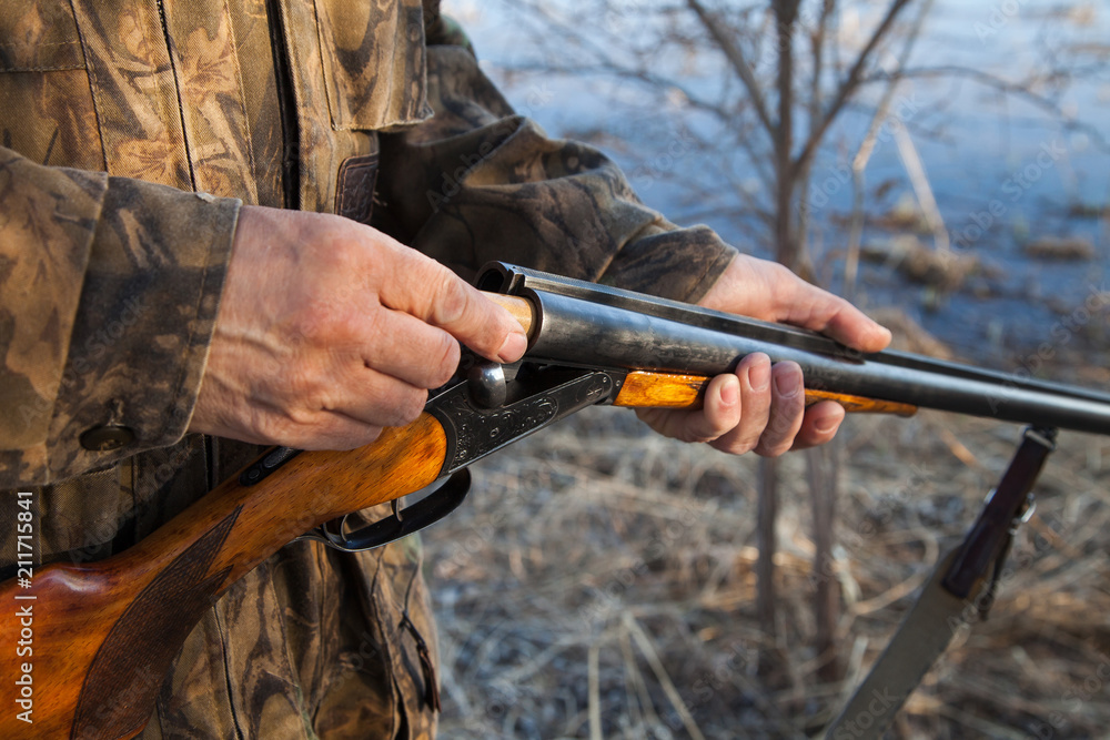 Fototapeta premium Hunter loading a double-barreled gun