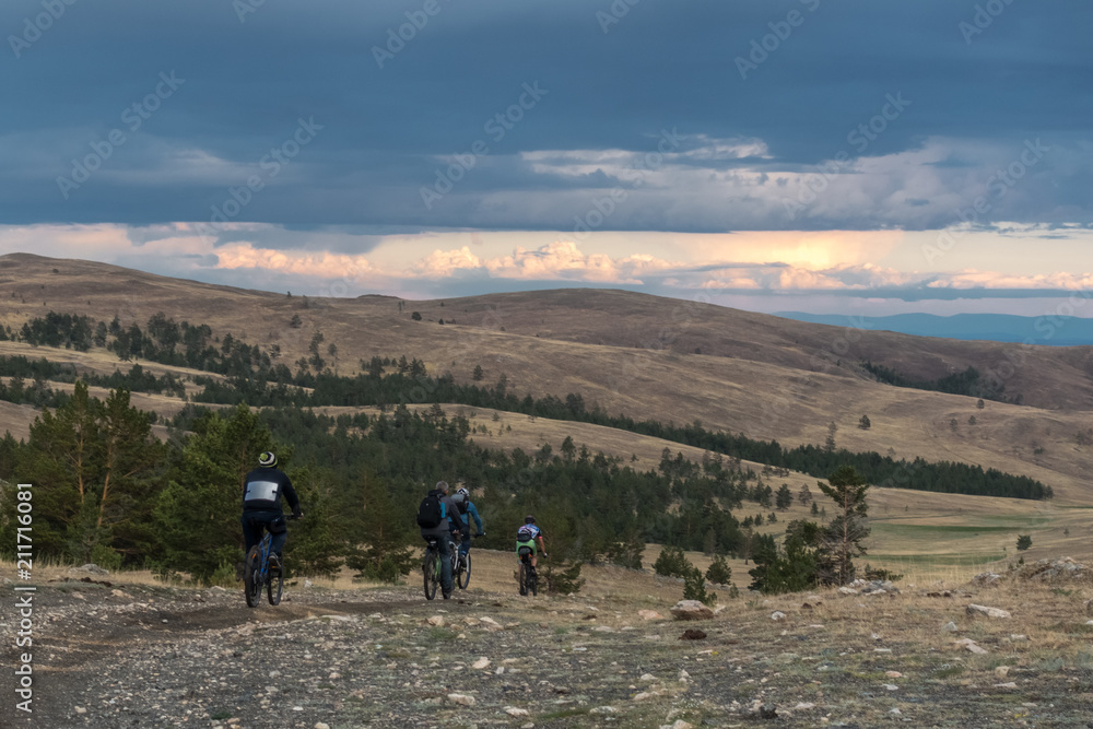 A group of cyclists riding along the Tazheran steppes A group of cyclists riding along the Tazheran steppes