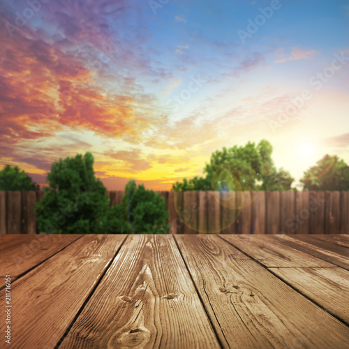 Fotografija Wooden product table top with blurred outdoor backyard background