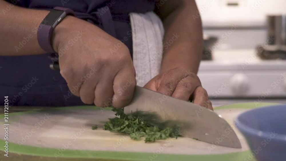 Closeup on hands chopping parsley, SLOWMO Closeup on hands chopping parsley, SLOWMO