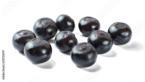 Glossy dark blueberries isolated on white background.