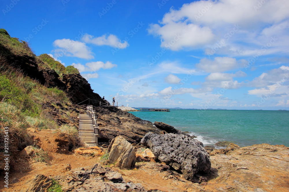 Rocks and calm sea with islands on the horizon and white clouds,Blue sky for background.At Khao Laem Ya - Mu Ko Samet National Park