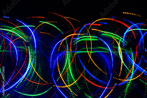 Fototapeta Naklejka Na Ścianę i Meble -  Blur colourful Abstract background of glowing stripes of streaks of light bands in a form of several lines on black background. Long exposure