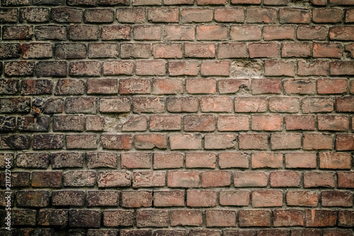 Red old worn brick wall texture background. Vintage effect. Background. Old brick wall in the background. Old brick close-up with plaster. Grunge Brick Wall With Broken Plaster Texture. The wall.