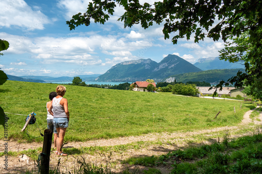 two women looking at  Annecy lake in France