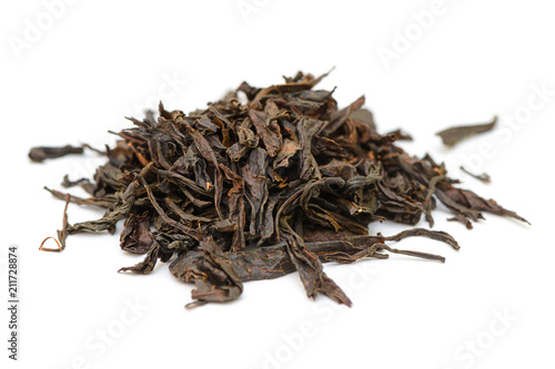 bunch of black tea leaves on a white background