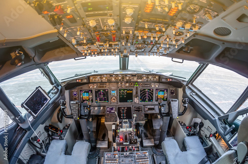 Fotótapéta Passenger aircraft interior, engine power control and other aircraft control unit in the cockpit of modern civil passenger airplane