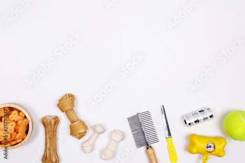 Pet accessories, food and toy on white background. Flat lay. Top view.