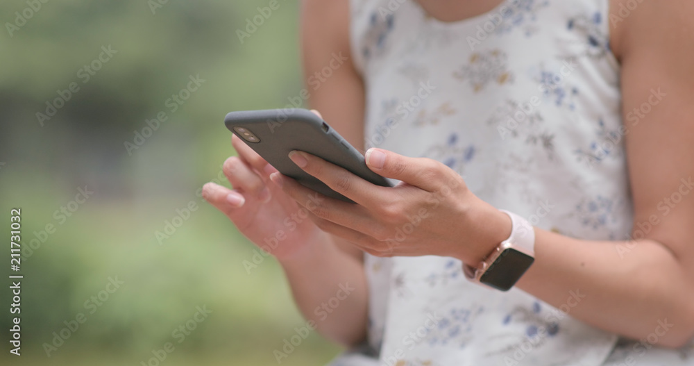 Woman use of cellphone in city park Woman use of cellphone in city park
