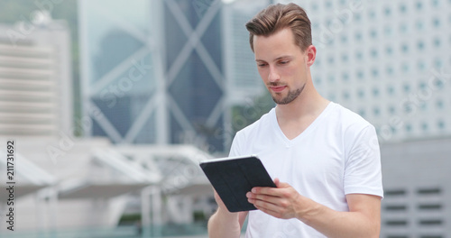 Photography Caucasian young man use of tablet computer