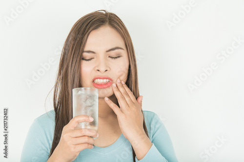 Sensitive teeth in woman And a glass of cold water photo