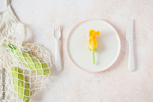 zucchini flowers in a plate on a light background photo