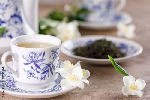 Refined forrhorn cup with a fragrant green tea with a taste of jasmine. photo