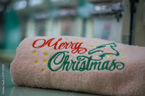 Embroidery text "Merry Christmas" on towel as a gift