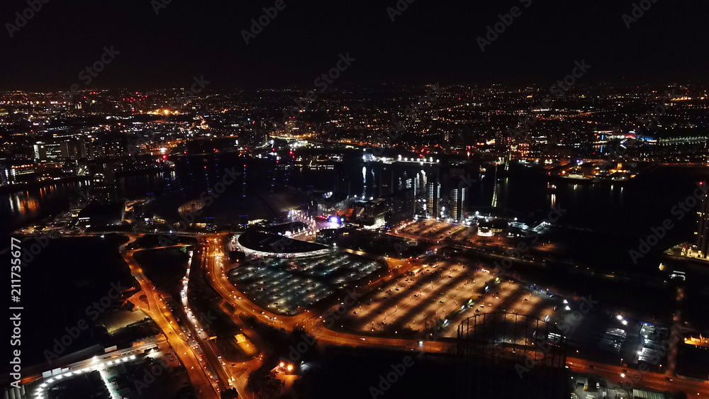 Obraz premium Aerial drone bird's eye view night shot of iconic O2 Arena as seen from Greenwich Peninsula, Isle of Dogs, London, United Kingdom