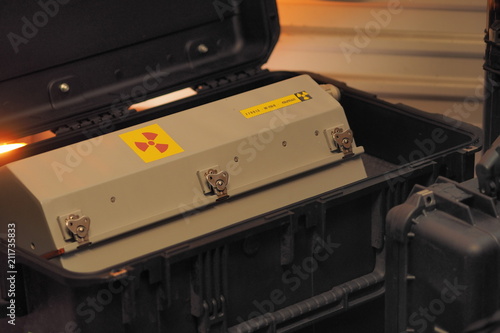 Fotografi Box shaped metal container with radiation warning in a military grade transport
