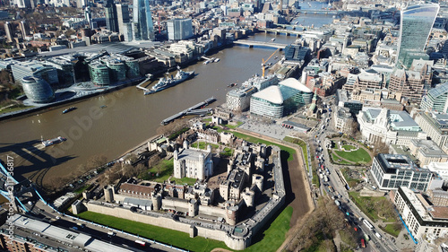 Aerial drone bird's eye view of iconic fortified Tower of London next to Tower bridge in City of London, United Kingdom
