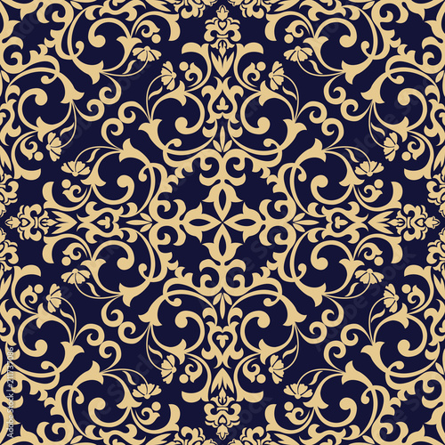 Wallpaper in the style of Baroque. Seamless vector background. Dark blue and gold floral ornament. Graphic pattern for fabric, wallpaper, packaging. Ornate Damask flower ornament