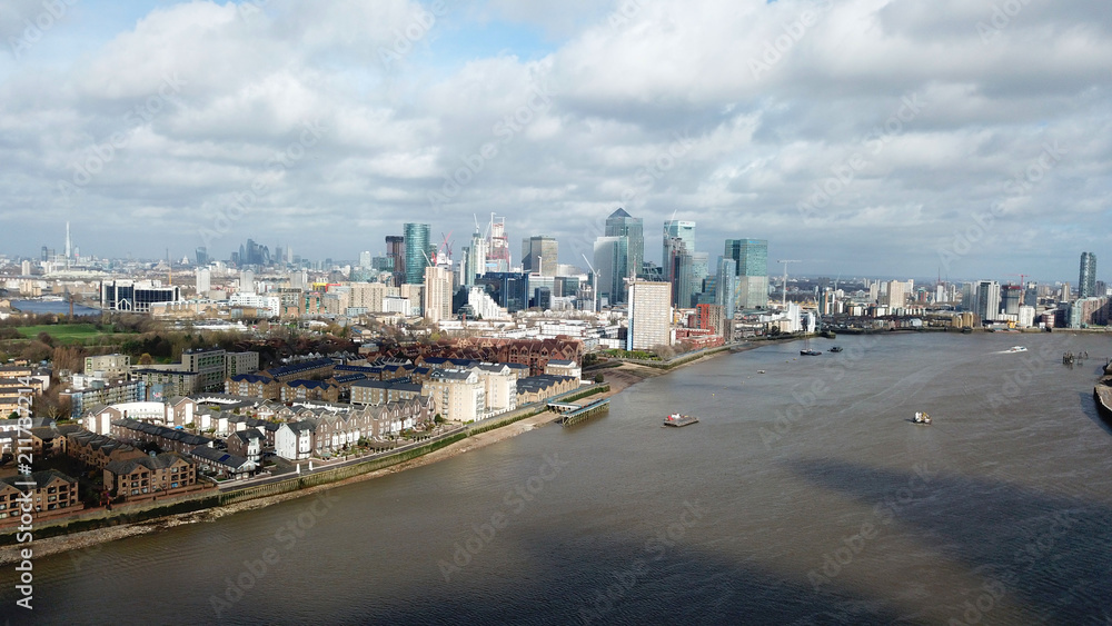 Obraz premium Aerial bird's eye view photo taken by drone of famous Docklands and Canary Wharf skyscraper complex, Isle of Dogs, London, United Kingdom