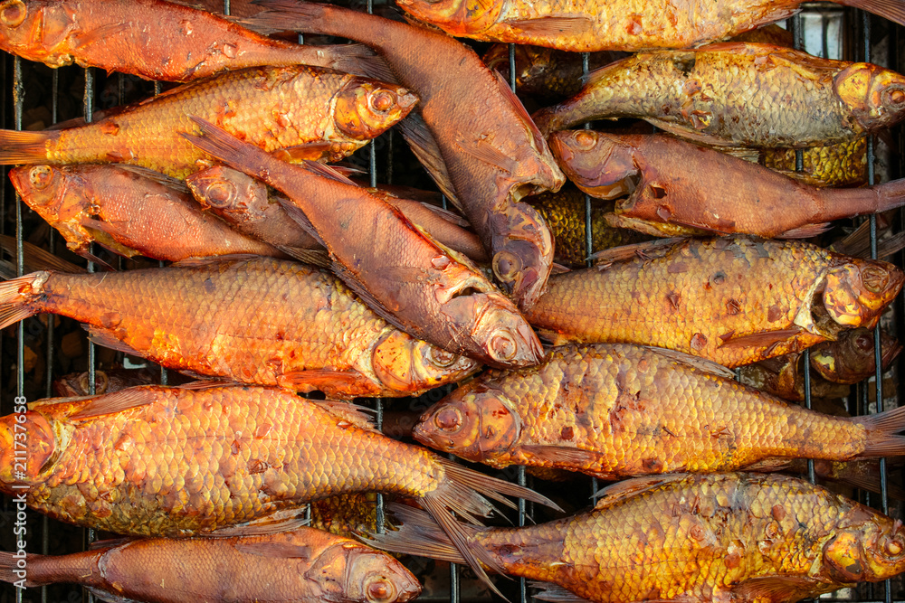 river fish lies in the smokehouse, which stands on the grass river fish lies in the smokehouse, which stands on the grass