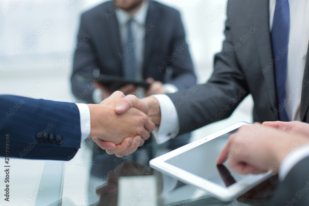 Men shaking hands with smile at office with their coworkers. Men shaking hands with smile at office with their coworkers.