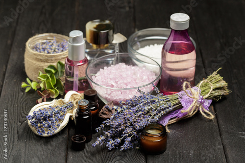 Aromatic composition of lavender, herbs, cosmetics and salt on a dark table top