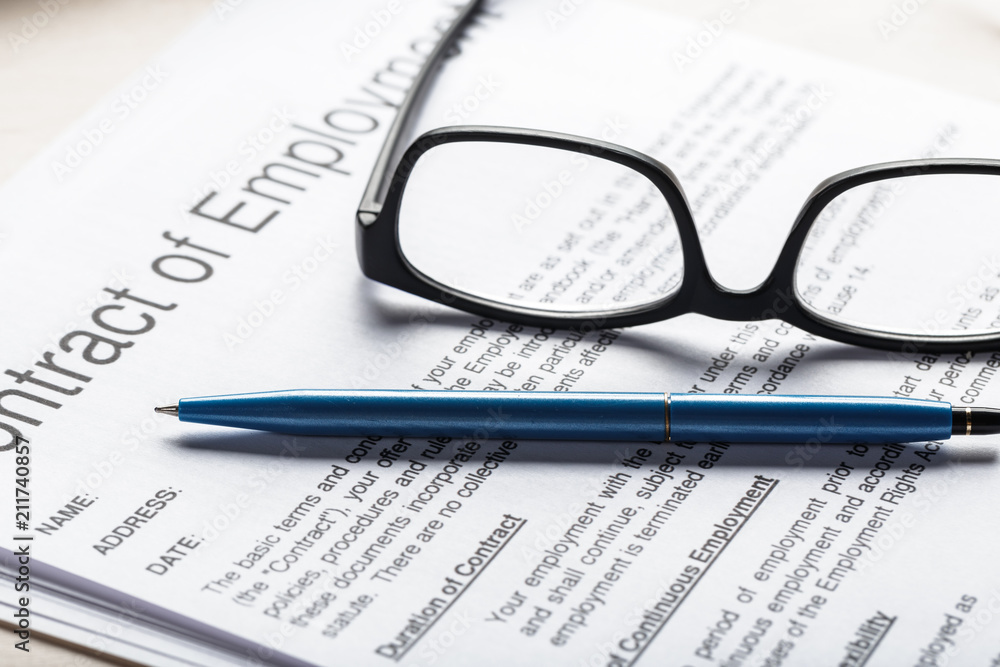 Close up shot of Eyeglasses on contract document papers business concept Close up shot of Eyeglasses on contract document papers business concept