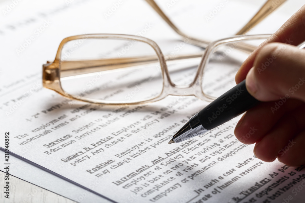 Close up shot of Eyeglasses on document papers business concept Close up shot of Eyeglasses on document papers business concept