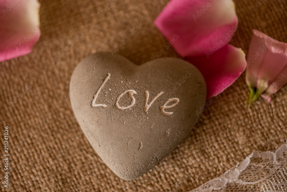 Obraz premium stone in a shape of heart with LOVE engraved 