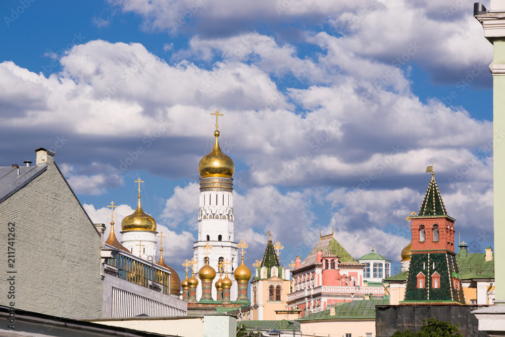 Beautiful view of the architectural ensemble of the Moscow Kremlin with blue cloudy sky and domes of temples