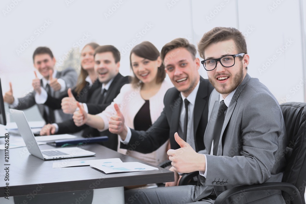 business team with thumbs up while sitting at his Desk business team with thumbs up while sitting at his Desk