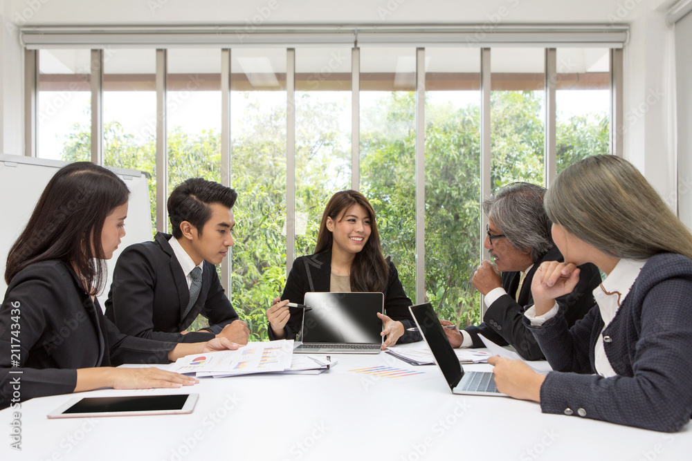 Team of asian business posing in meeting room. Working brainstorming on the table in a room. asian people. The office. presentation with computer. Team of asian business posing in meeting room. Working brainstorming on the table in a room. asian people. The office. presentation with computer.