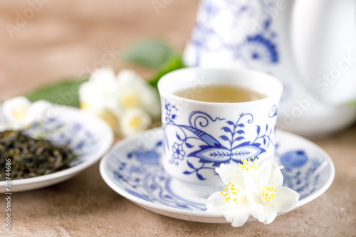 A porcelain cup with green tea with a taste of jasmine.