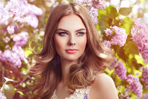 Beautiful Woman with Flowers of Lilac. Spring Blossom. Sexy Glamour Summer Beautiful Lady with Healthy and Beauty Hair © Oleg Gekman