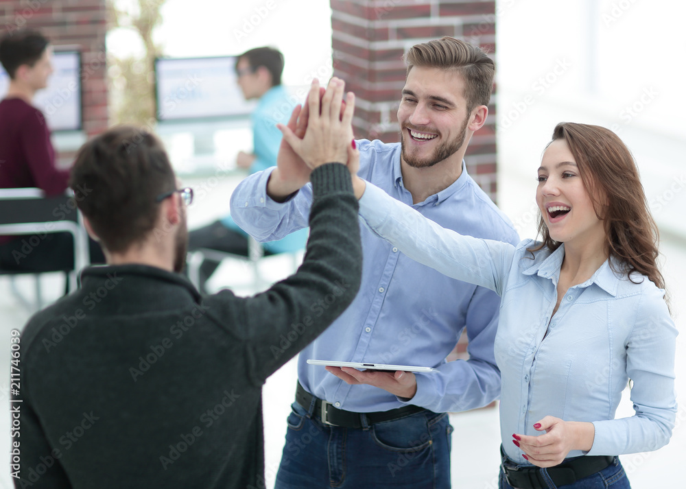 Happy business team using tablet in office. Happy business team using tablet in office.