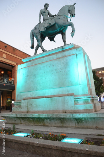 The Lady Godiva statue in Coventry city centre lit up at night photo