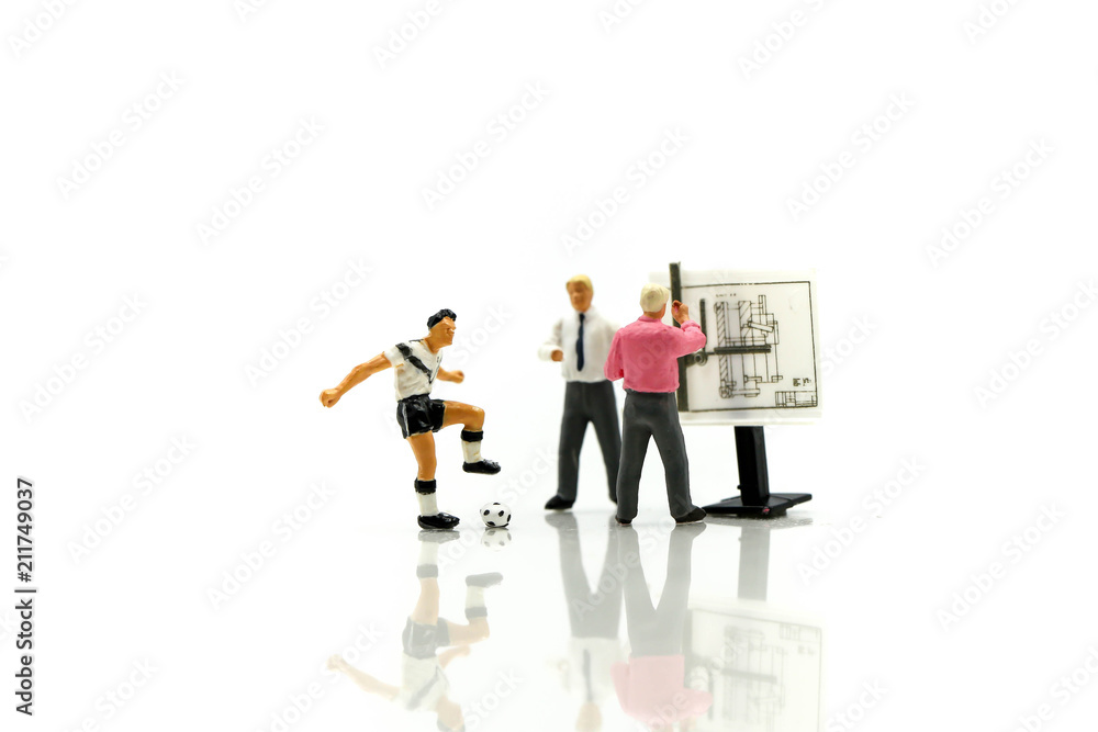 Miniature people : Soccer Football Coaches are Planning with the Players in the Tournament. Miniature people : Soccer Football Coaches are Planning with the Players in the Tournament.