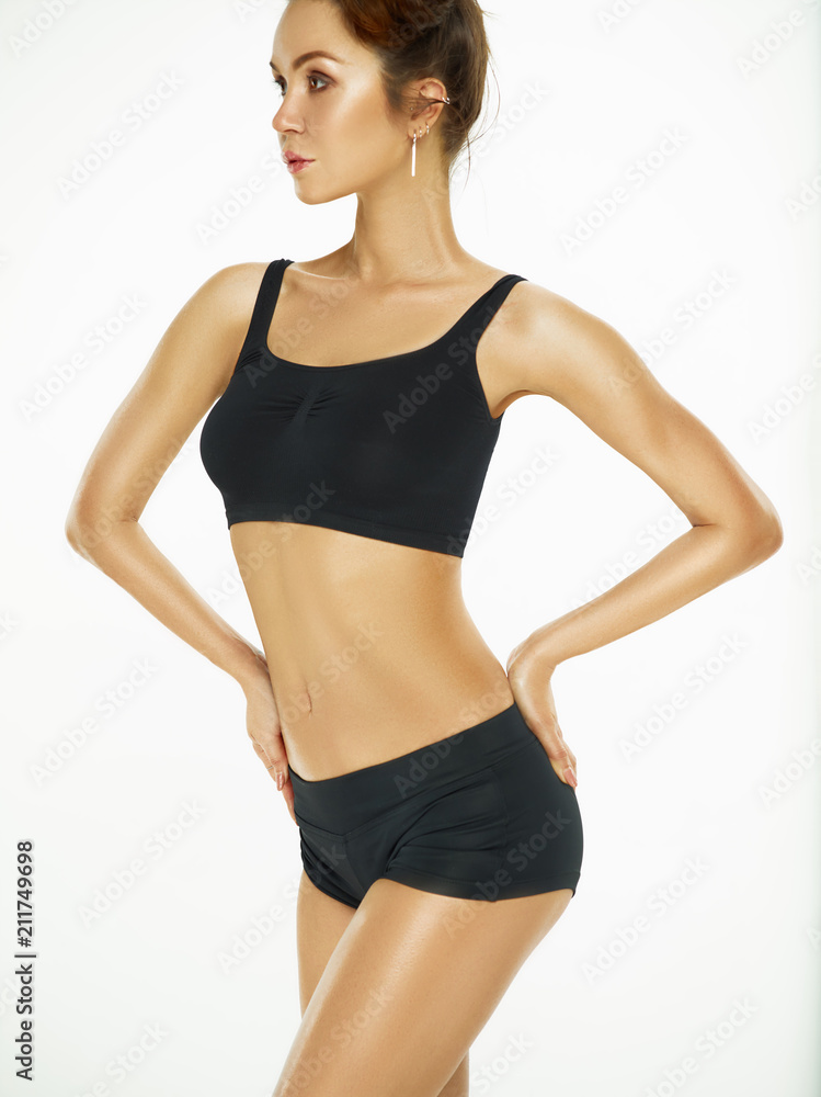 Fototapeta premium Muscular young woman athlete posing at studio
